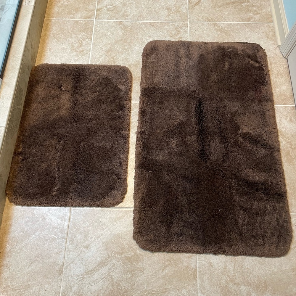Two chocolate brown bath rugs